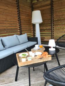 a living room with a couch and a table at La Maison des Eaux Claires in Puymoyen