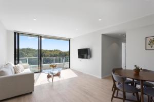 a living room with a couch and a table at Pinnacle on the Park in Gold Coast