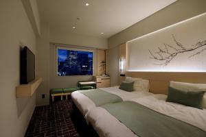 a hotel room with a bed and a window at Hotel Yaenomidori Tokyo in Tokyo