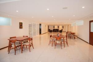a dining room with wooden tables and chairs at The Crossroads Hotel, Westlands in Nairobi
