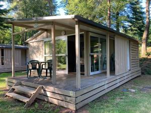 a screened in porch on a tiny house at Domaine du Lac in Soursac