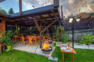 a patio with a fire pit in the grass at Sarenka in Krynica Zdrój