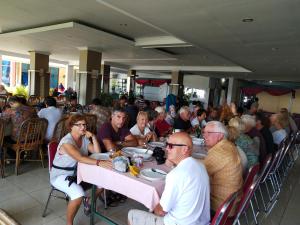 a large group of people sitting at tables in a restaurant at Bukit Kenari Hotel & Restaurant in Parepare