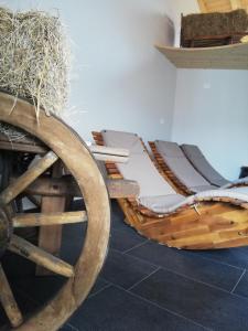 a wooden carriage with hay on top of it at Albergo Neni in Brentonico