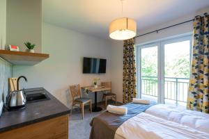 Posteľ alebo postele v izbe v ubytovaní Aparthotel Pod Stokiem z sauną i jacuzzi - szczyrkapartamenty