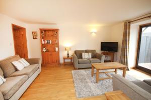 a living room with a couch and a tv at Quay Quarters in Chichester