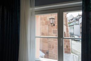 a window with a view of a brick building at Oldtown Studios by dasPaul in Nuremberg +30 photos