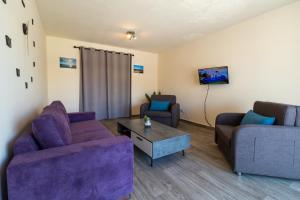 a living room with two couches and a coffee table at Leucolla Hill & Sea in Protaras