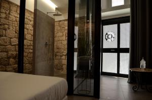 a bedroom with a bed and a walk in shower at Covo del Carbonaro in Ascoli Piceno
