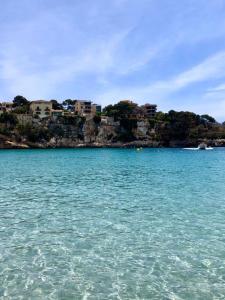 a large body of water with houses on a hill at Sa Marineta in Porto Cristo