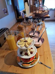 a table topped with plates of food and drinks at Tattoo PENSION in Mörtschach