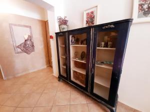 une armoire noire avec des étagères dans une pièce dans l'établissement Anthemio, à Loutraki