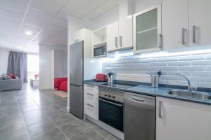 a kitchen with a sink and a refrigerator in a room at Loft Life 3 in Arrecife