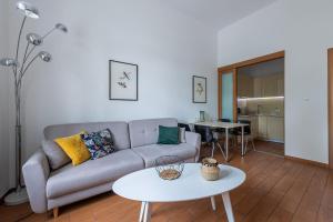 a living room with a couch and a table at Novis Apartments Krakowskie Przedmieście in Warsaw