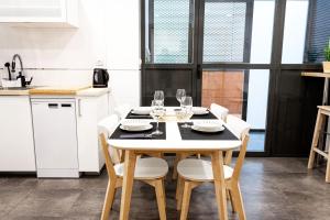 a kitchen with a table with wine glasses on it at Dolaretxe apartment by People Rentals in Bilbao +14 photos