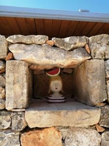 a doll sitting in a stone wall at Tenuta Colavecchio B&B in Putignano
