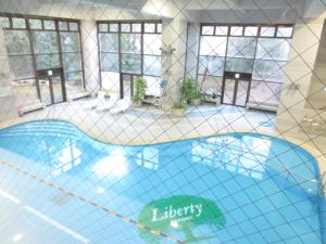 a large swimming pool in a room with windows at Hakone Forest of Verde in Hakone