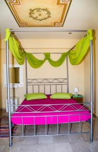 a bedroom with a bed with a purple canopy at Condillia II in Spetses