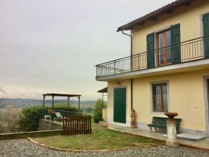 a house with a bench and a gazebo next to it at Casapaletti Country House in Alfiano Natta +53 photos