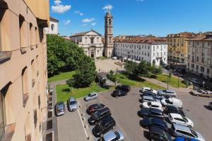 a parking lot full of cars in a city at Duomo Luxury Apartment IV in Milan