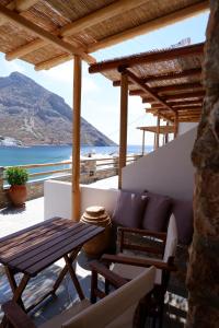 a patio with a couch and a table and a view of the ocean at Grand View in Kamares