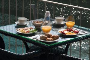 a table with a tray of breakfast foods and orange juice at Quinta de la Rosa in Pinhão