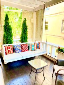 a porch with a swinging couch and a table at Sadovnicheskaya City Center in Moscow