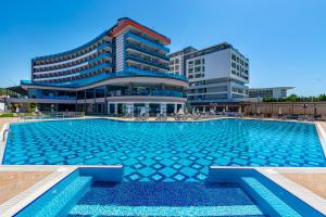 a large swimming pool in front of a building at Lonicera Premium - Ultra All Inclusive in Avsallar
