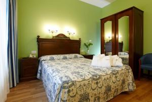 a bedroom with a bed and a large mirror at Gran Hotel Balneario de Liérganes in Liérganes