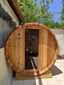 a wooden barrel on the side of a building at Dimora Assuntina Martano in Martano