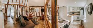 a living room with a staircase in a house at Les Gites de Claire in Saint-Gâtien-des-Bois