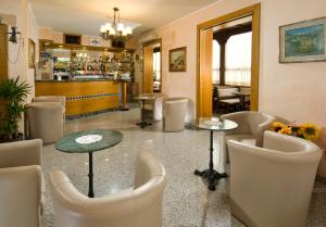 a restaurant with chairs and tables and a bar at HOTEL CASADEI in Rimini