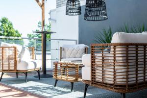 a patio with rattan chairs and a table at Hotel Arkipelag in Mariehamn