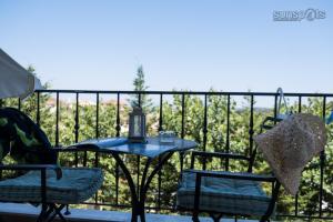 a table and chairs on a balcony with a view at Villa Konstantina in Petrití