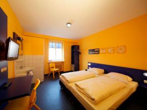 a hotel room with a bed and a sink at Bed’nBudget Expo-Hostel Dorms in Hannover