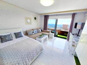 a bedroom with a bed and a living room at Mirador 22 in Alicante