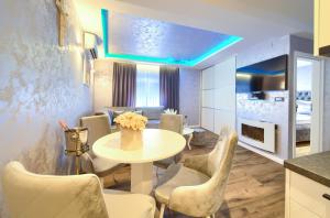 a dining room with a table and chairs at Luxury Apartments JF in Rab