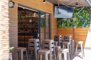 a row of stools sitting in front of a restaurant at Luxury Apartments JF in Rab