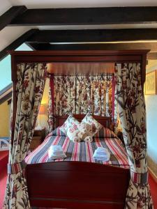 
A bed or beds in a room at The Steadings, at The Grouse & Trout
