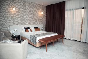 a hotel room with a bed and a couch at THE PALMS Luxury Boutique Hotel in Dakar +23 photos