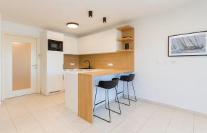 a kitchen with a counter and stools in a room at Premium Marina Apartments with Sea View by Locap Group in Portorož