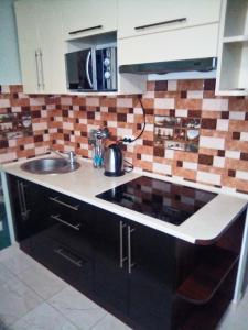 a kitchen with a sink and a counter top at 1-комнатная квартира-студия Люкс Элитный дом-2016 Центр in Truskavets +4 photos