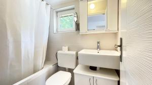 a small bathroom with a toilet and a sink at Apartments Antonela in Sveti Stefan +53 photos