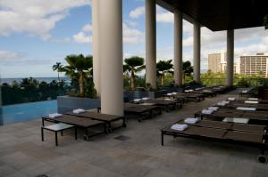 a row of tables on the roof of a resort at Jet Luxury Private Residences in Waikiki in Honolulu