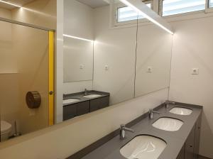 a bathroom with three sinks and a large mirror at Alberg Barcelona Xanascat in Barcelona +66 photos