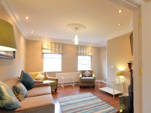 a living room with a couch and a table at Luxurious KC House in Dungannon