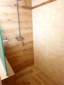 a bathroom with a wooden floor and a shower stall at Volyn in Volodymyr-Volynskyi
