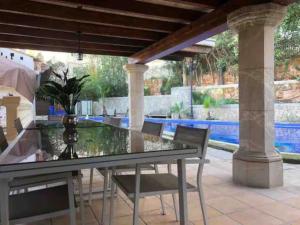 une table et des chaises en verre sur la terrasse dans l'établissement Palma Ambassador Center ETV14825, à Palma de Majorque