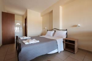 a bedroom with a large bed with towels on it at Socrates Hotel in Sidari +60 photos