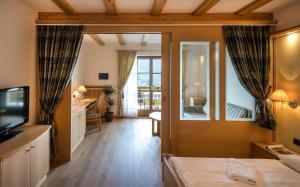 um quarto de hotel com uma cama e um espelho em Hotel Gasthof Waldschenke em Marlengo